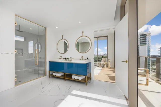 a room with painting on the wall and a glass door