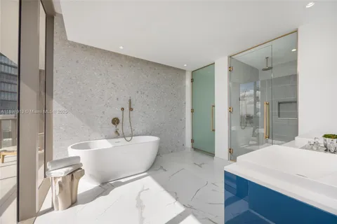 a bathroom with a sink a toilet a mirror and shower