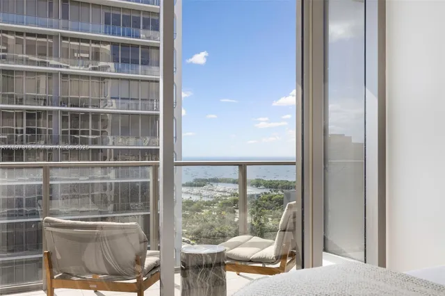 a bedroom with a bed and glass window