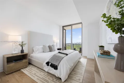 a bedroom with a bed and a potted plant