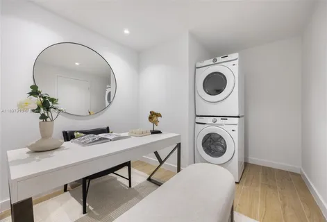 a living room with a sink furniture and a mirror