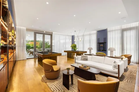 a view of a dining room with furniture a chandelier and wooden floor