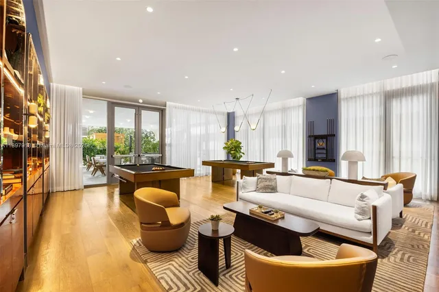 a view of a dining room with furniture a chandelier and wooden floor