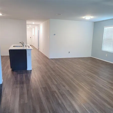 a view of a room with wooden floor and window