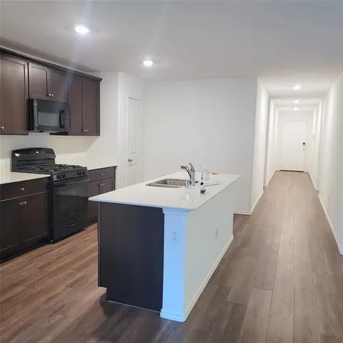 a kitchen with a sink and cabinets