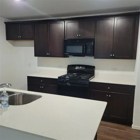 a kitchen with a sink and a stove top oven