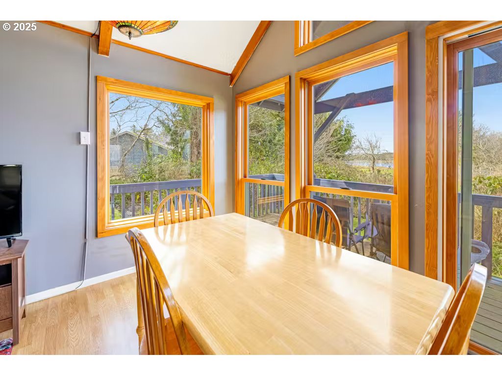 25990 Sandlake Road Cloverdale, OR 97112 - Photo 11 of 40 a bedroom with a bed and a large window