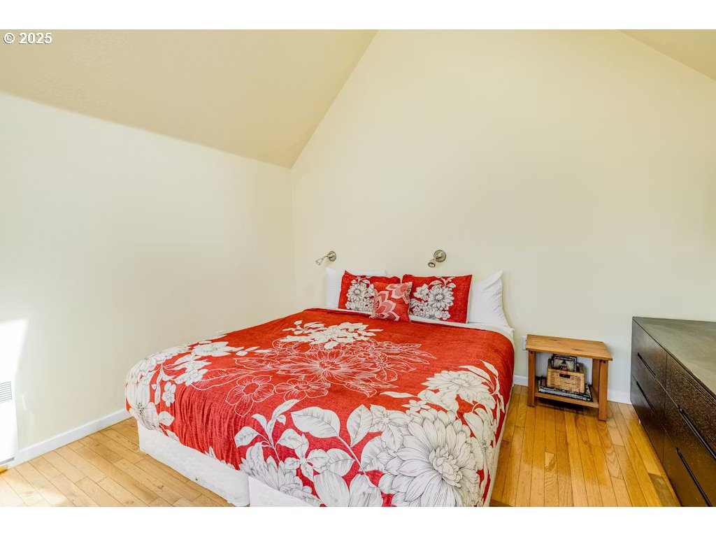 25990 Sandlake Road Cloverdale, OR 97112 - Photo 15 of 40 a bedroom with a bed and cupboard