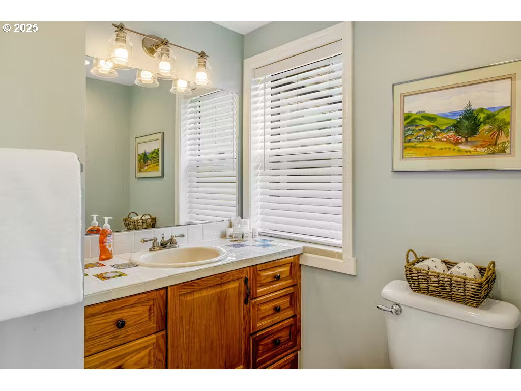 25990 Sandlake Road Cloverdale, OR 97112 - Photo 17 of 40 a bathroom with a sink a vanity and a mirror