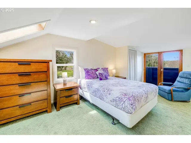 a bedroom with a bed and a dresser in it