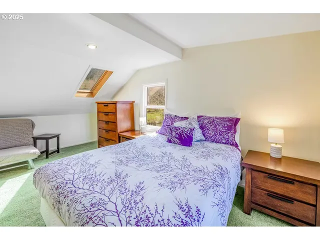 a bedroom with a bed and wall painting