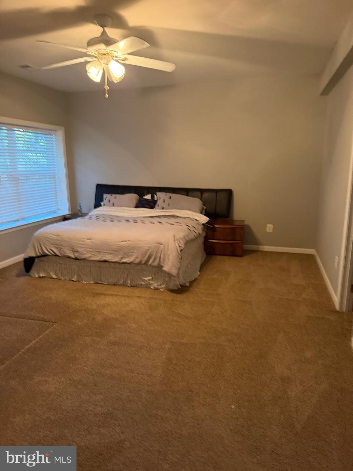 18970 Rosings Way Triangle, VA 22172 - Photo 8 of 16 a bedroom with a bed and a chandelier