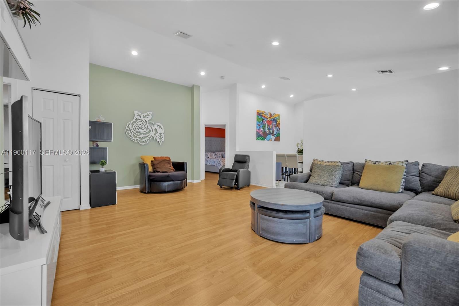 10337 Coventry Court Boca Raton, FL 33428 - Photo 13 of 44 a living room with furniture a flat screen tv and a sink