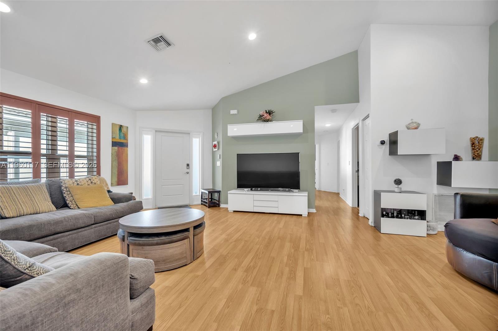 10337 Coventry Court Boca Raton, FL 33428 - Photo 15 of 44 a living room with furniture and a flat screen tv