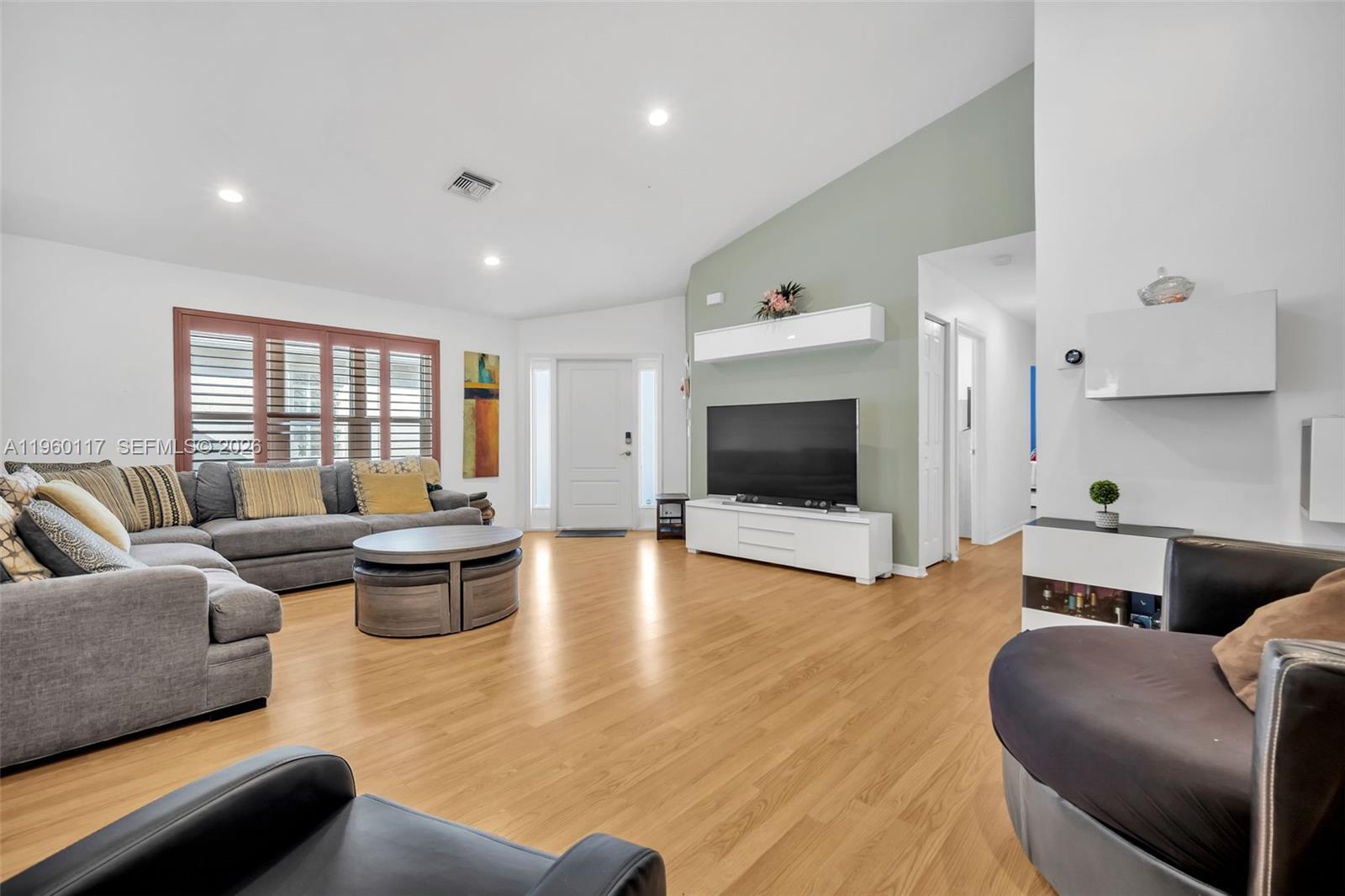 10337 Coventry Court Boca Raton, FL 33428 - Photo 16 of 44 a living room with furniture and a flat screen tv
