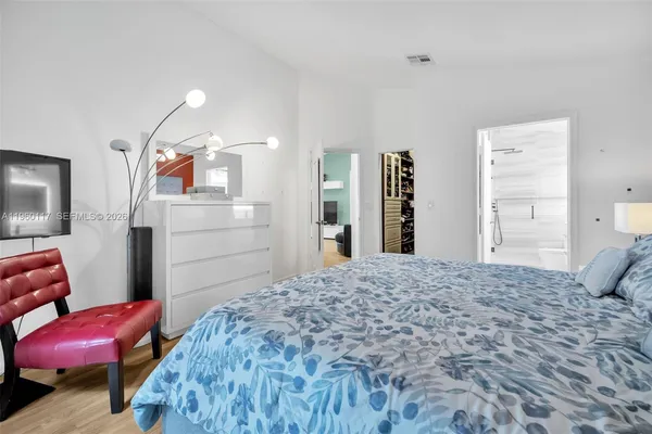 a bedroom with a bed and dresser