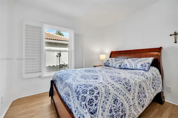 a bedroom with a bed and a night stand