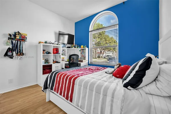 a bedroom with a bed and a fireplace