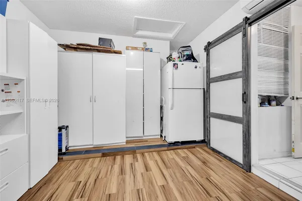 a view of a room with wooden floor and white walls