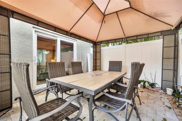 a view of a patio with table and chairs and potted plants