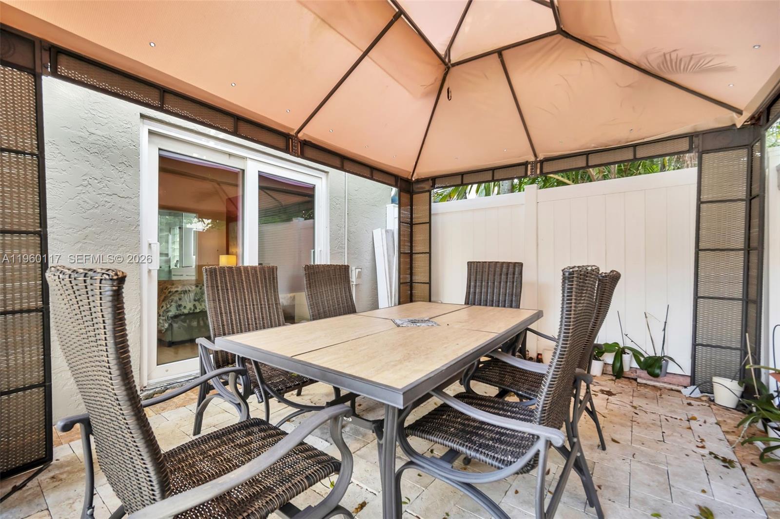 10337 Coventry Court Boca Raton, FL 33428 - Photo 34 of 44 a view of a patio with table and chairs and potted plants