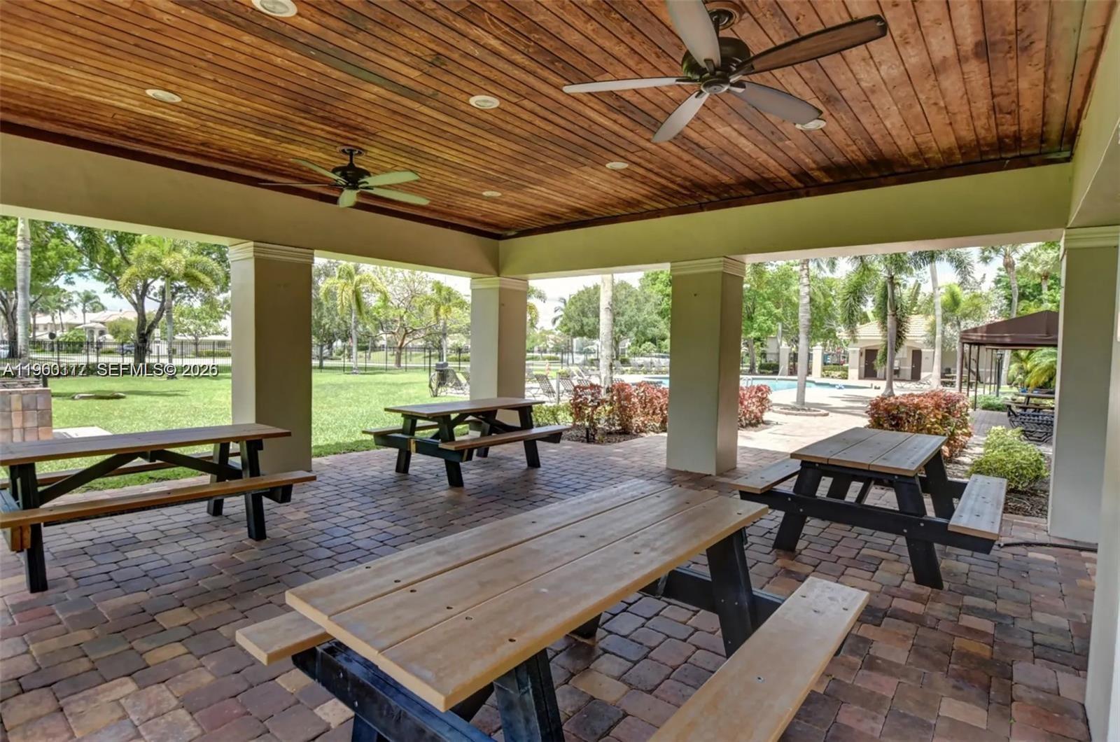 10337 Coventry Court Boca Raton, FL 33428 - Photo 40 of 44 a outdoor living space with furniture and a table