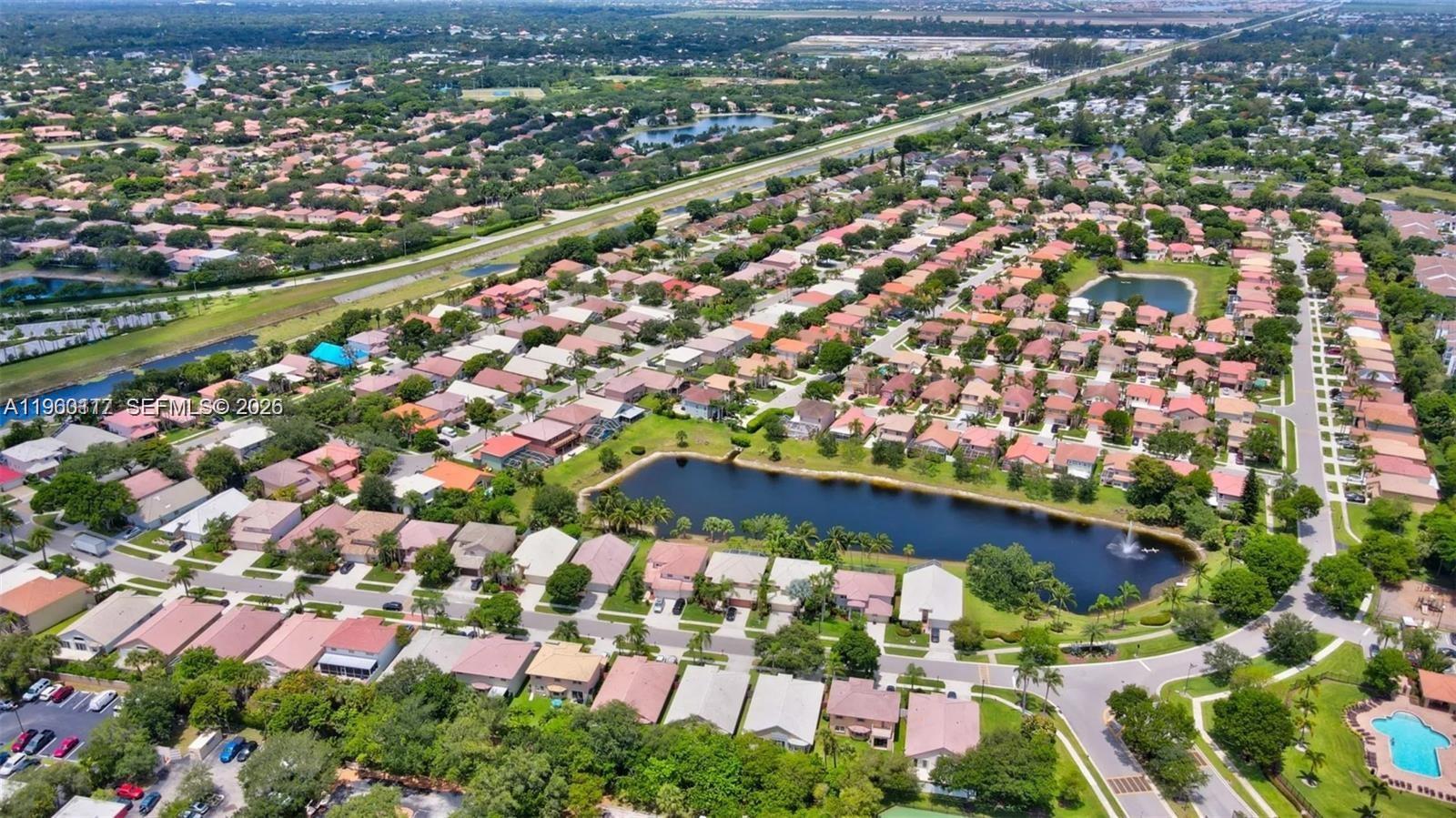 10337 Coventry Court Boca Raton, FL 33428 - Photo 43 of 44 an aerial view of residential houses with outdoor space and trees