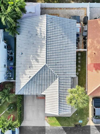 a view of a brick house with plants