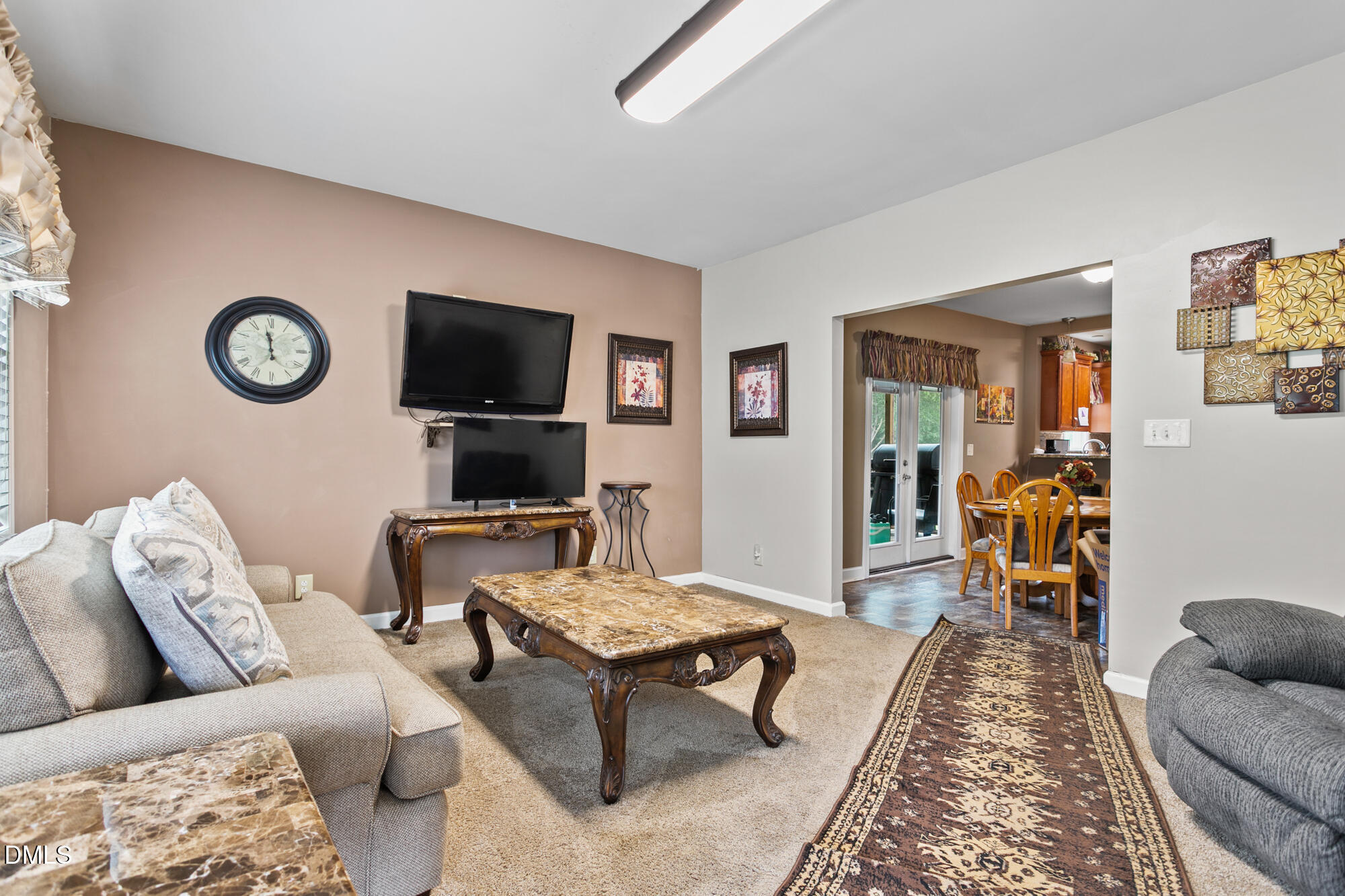 3163 Saul Loop Road Elon, NC 27244 - Photo 6 of 44 a living room with furniture and a flat screen tv