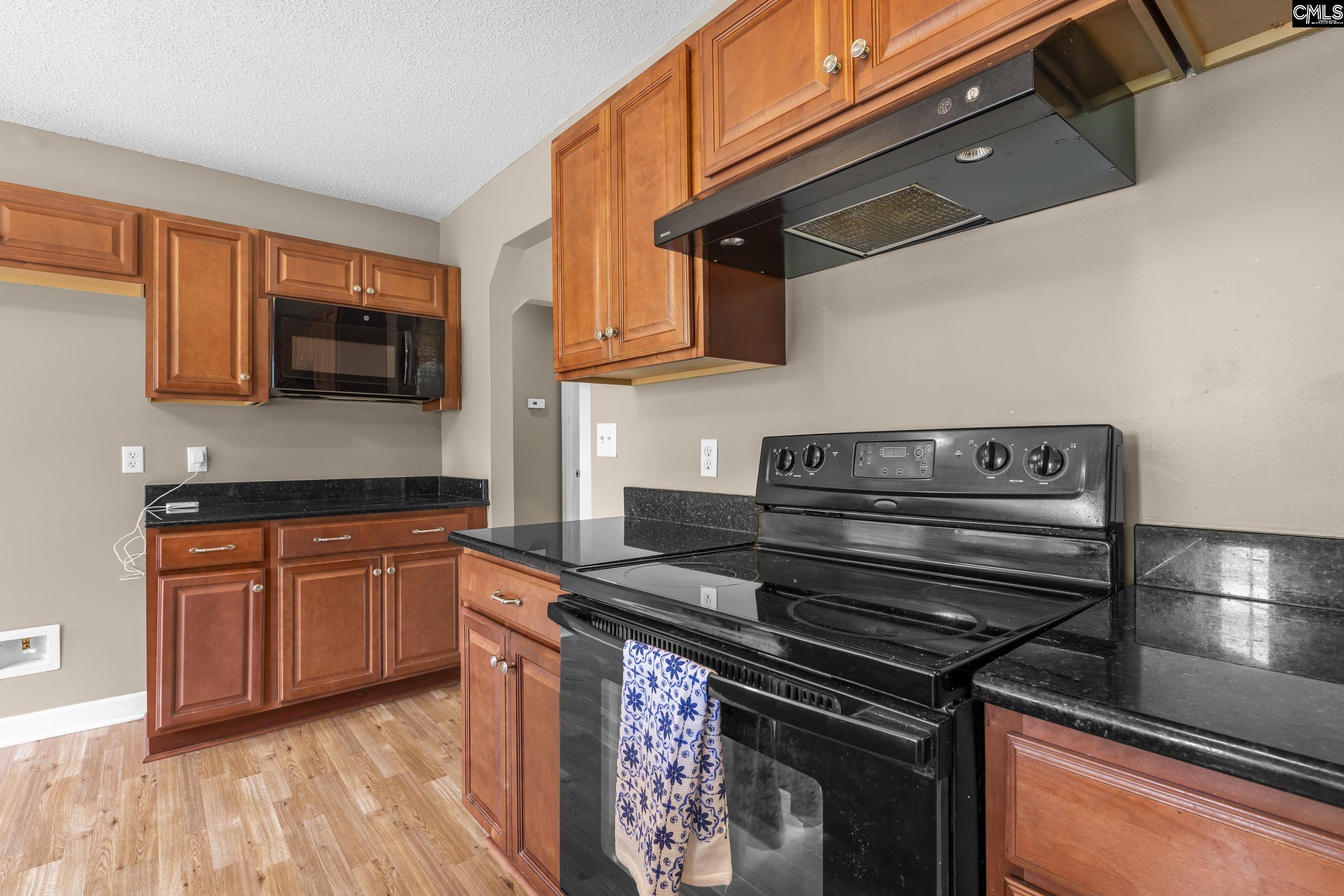 548 Eskie Dixon Road Elgin, SC 29045 - Photo 7 of 27 a kitchen with a stove and a microwave