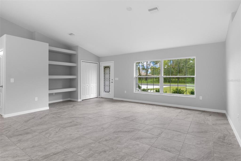 16375 Kakawi Road Brooksville, FL 34614 - Photo 4 of 30 a view of an empty room with a window and a room