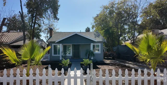 a front view of a house with a plant