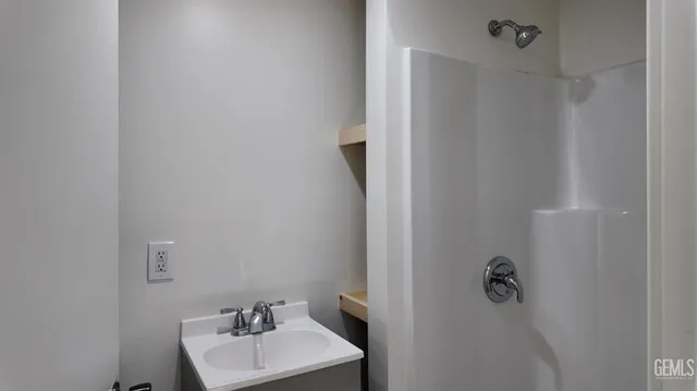 a bathroom with a sink a mirror and vanity