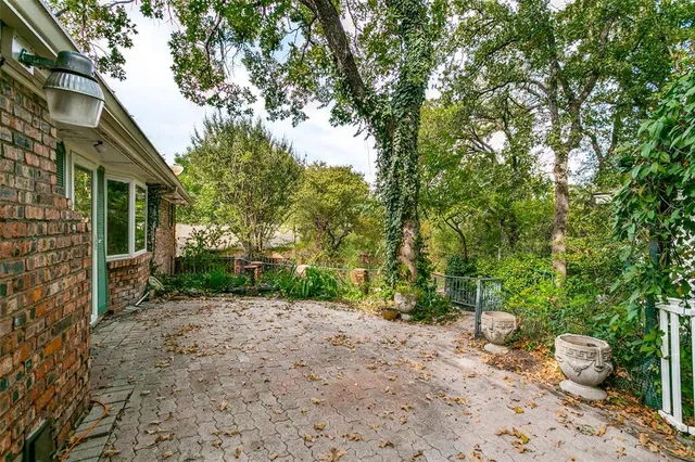 a view of a bedroom with a window and a ceiling fan
