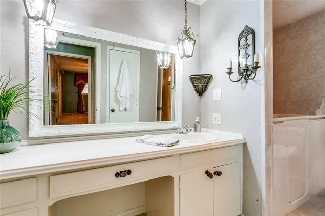 a bathroom with a sink a toilet and mirror