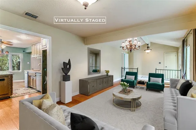 a living room with furniture and a chandelier