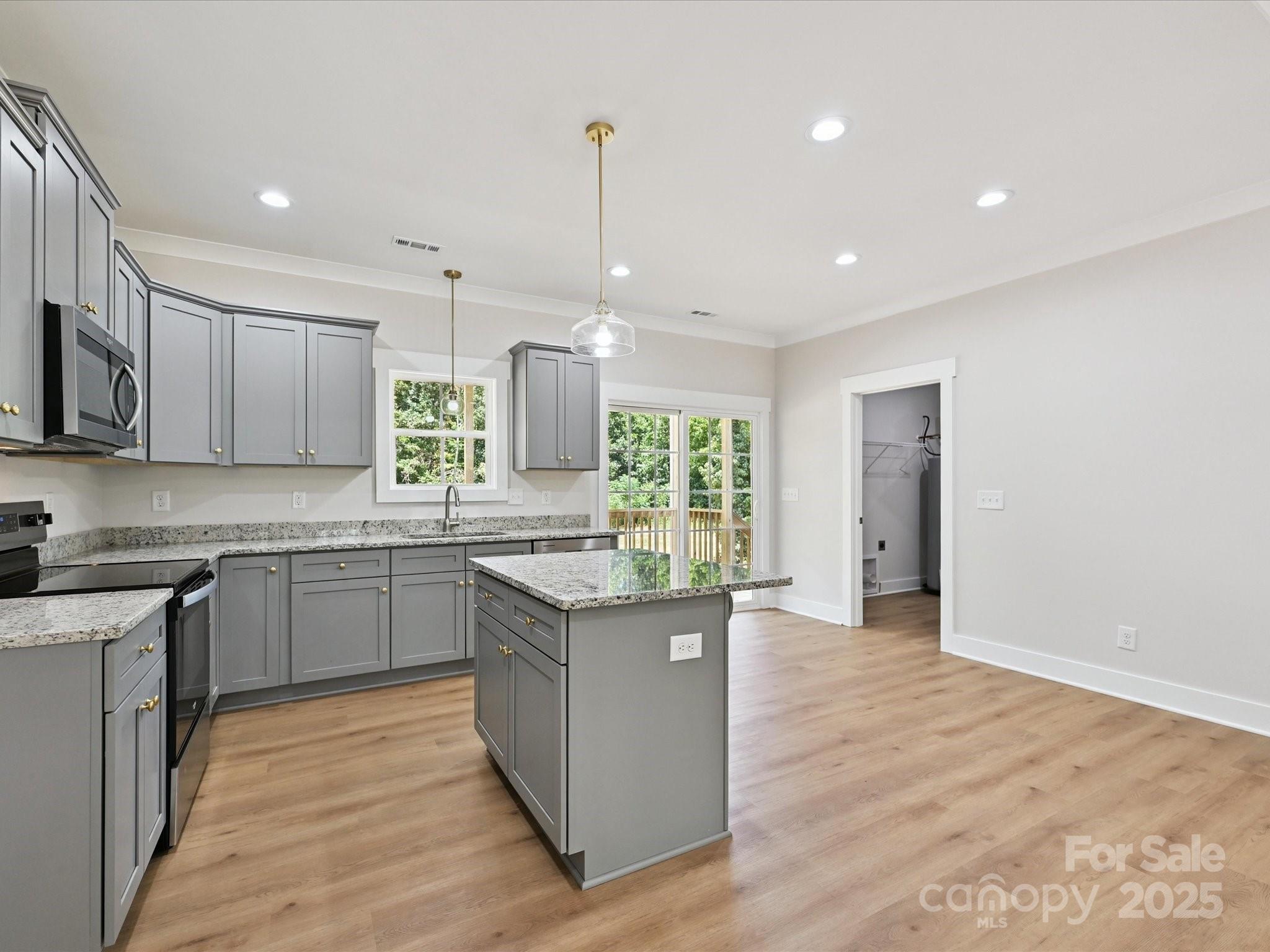 280 Old Pinckney Road York, SC 29745 - Photo 13 of 29 a kitchen with stainless steel appliances granite countertop a stove top oven a sink dishwasher and a refrigerator with wooden floor