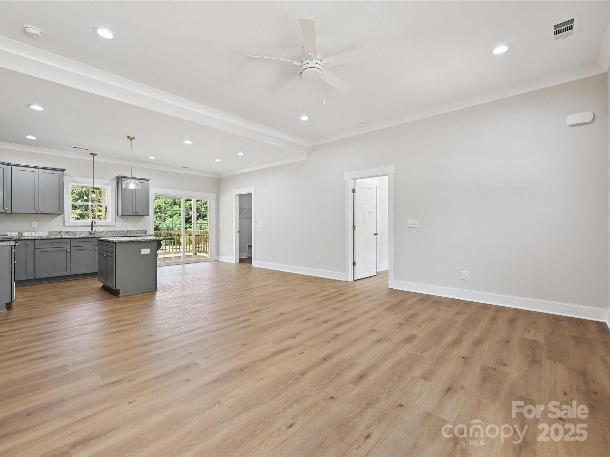280 Old Pinckney Road York, SC 29745 - Photo 15 of 29 an empty room with wooden floor and a kitchen