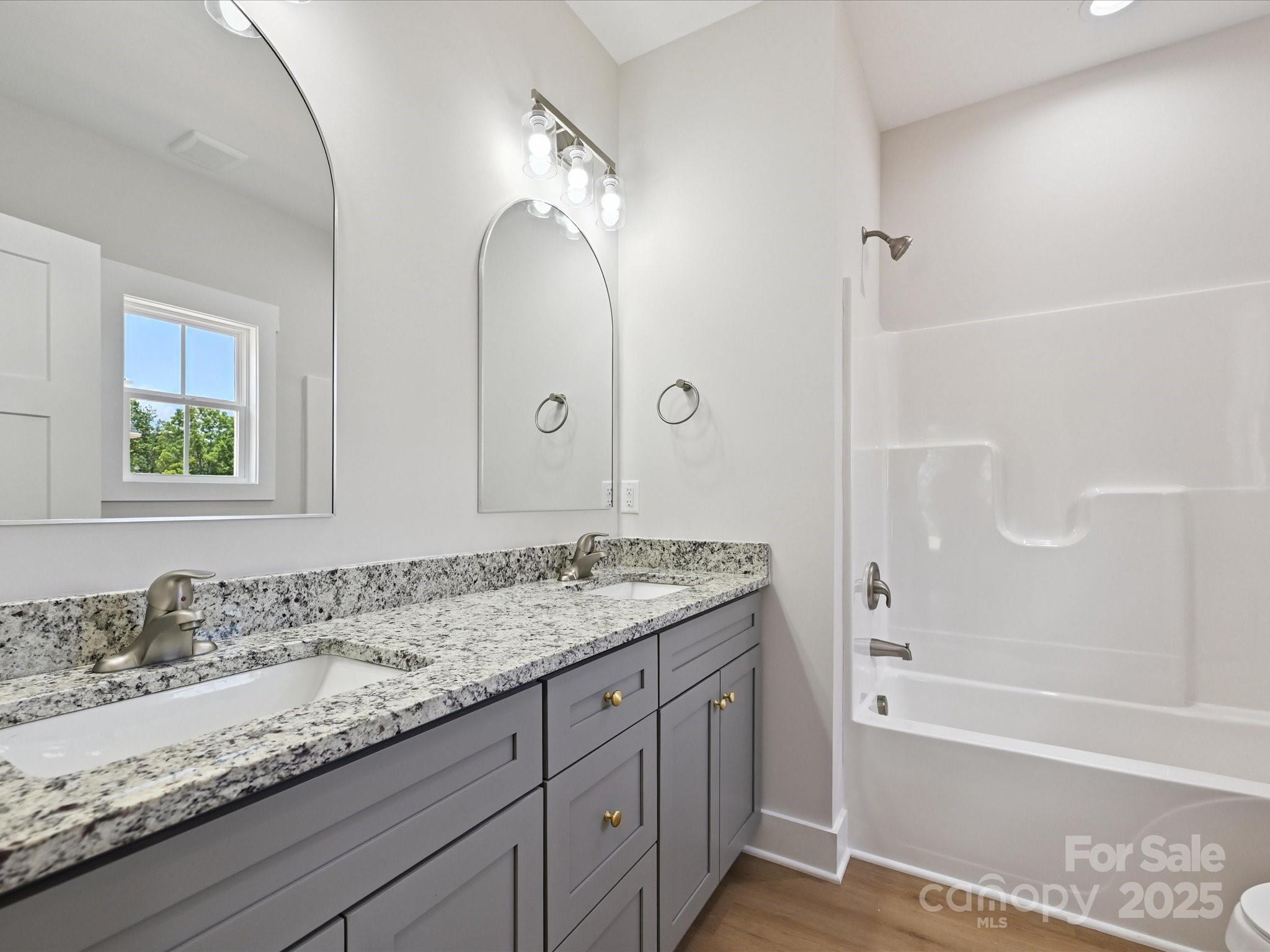 280 Old Pinckney Road York, SC 29745 - Photo 19 of 29 a bathroom with a granite countertop sink a mirror and a bathtub