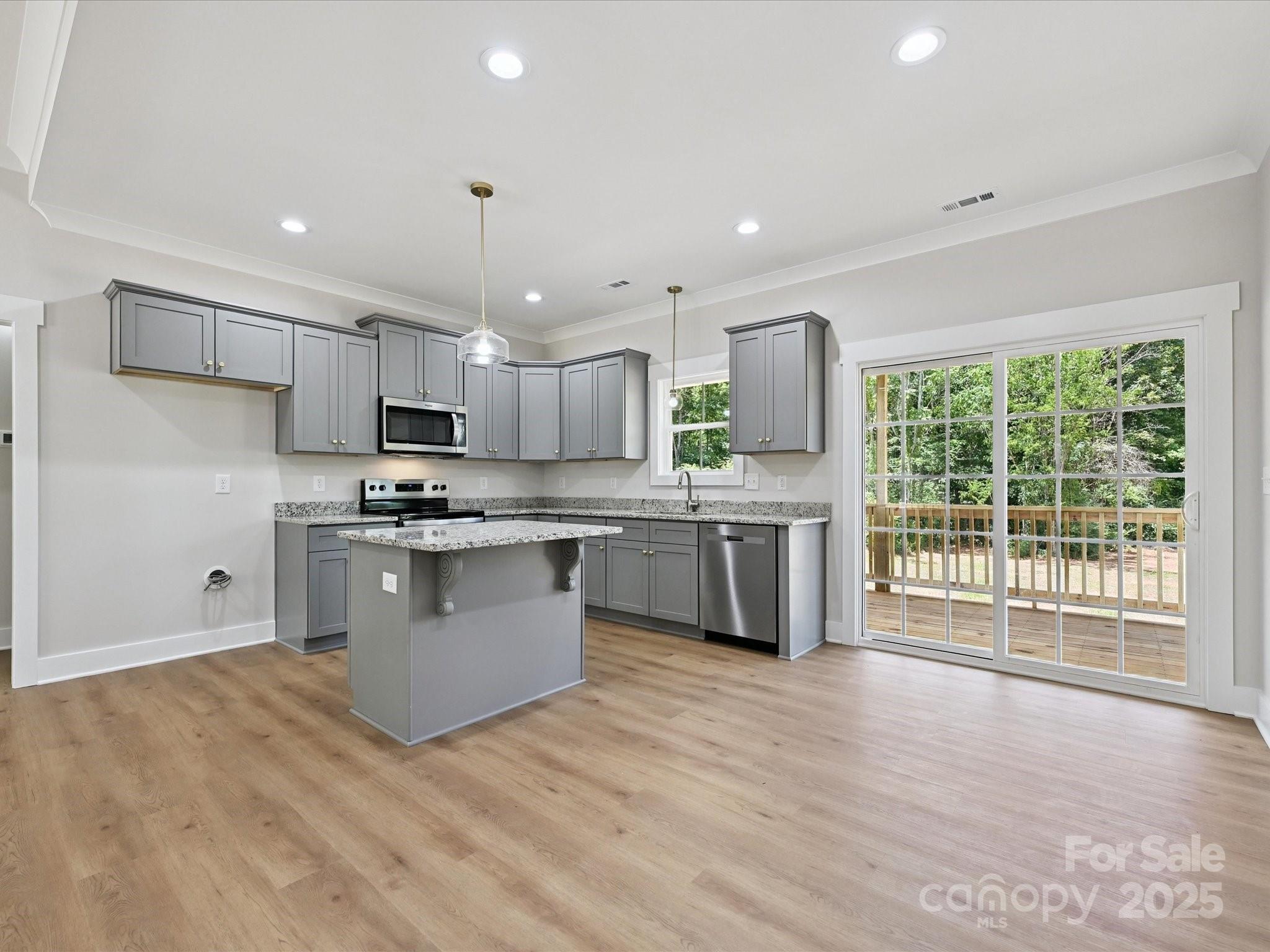 280 Old Pinckney Road York, SC 29745 - Photo 9 of 29 a kitchen with kitchen island granite countertop a stove top oven sink and cabinets