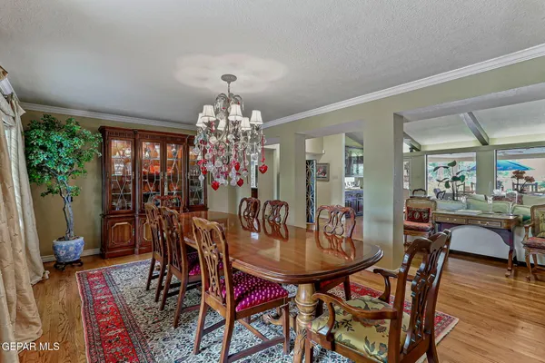 a view of a chairs and tables in patio and a wooden deck