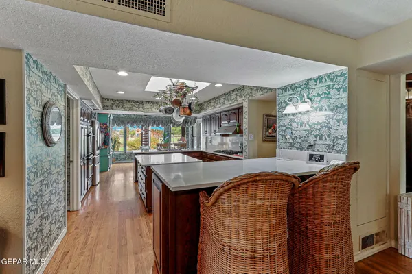 a view of a dining room with furniture and a potted plant