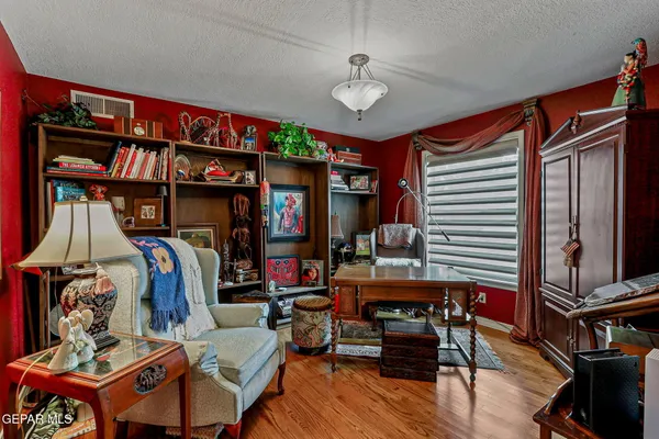 a view of a backyard with table and chairs under an umbrella with a small yard