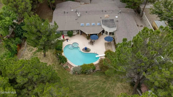 a kitchen with stainless steel appliances granite countertop a kitchen island a stove a table and chairs in it