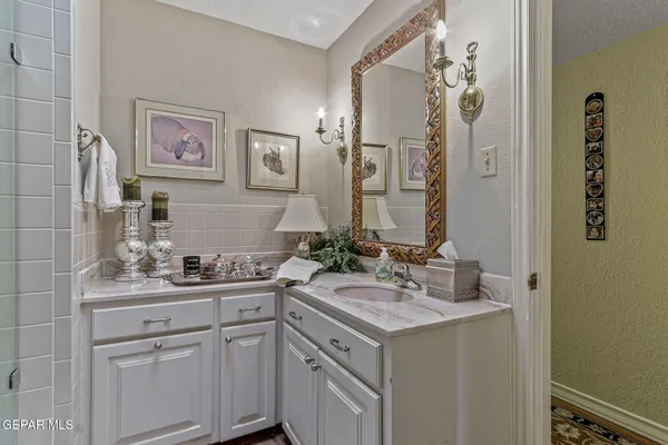 an aerial view of city and lake with trees all around