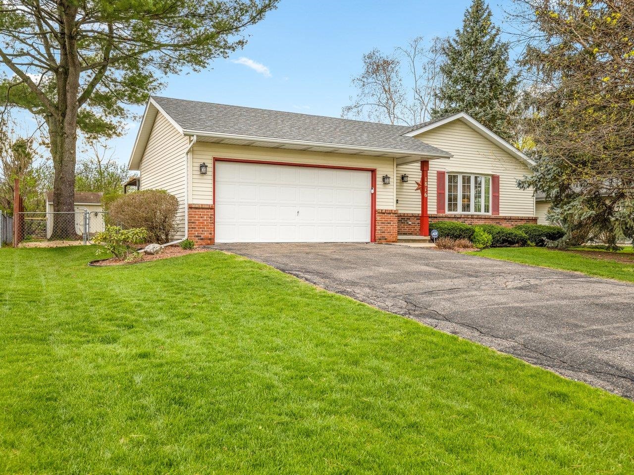 1816 Post Road Beloit, WI 53511 - Photo 3 of 42 a front view of a house with a yard and garage