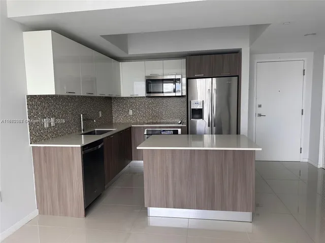 a kitchen with stainless steel appliances a microwave a stove and refrigerator