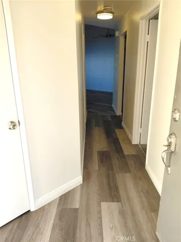 a view of a hallway with wooden floor