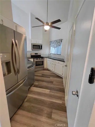 a kitchen with cabinets and stainless steel appliances