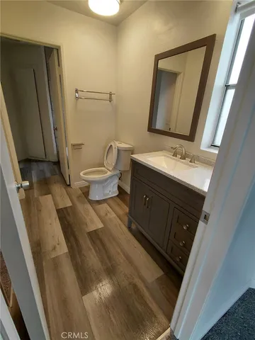 a bathroom with a sink a toilet and mirror